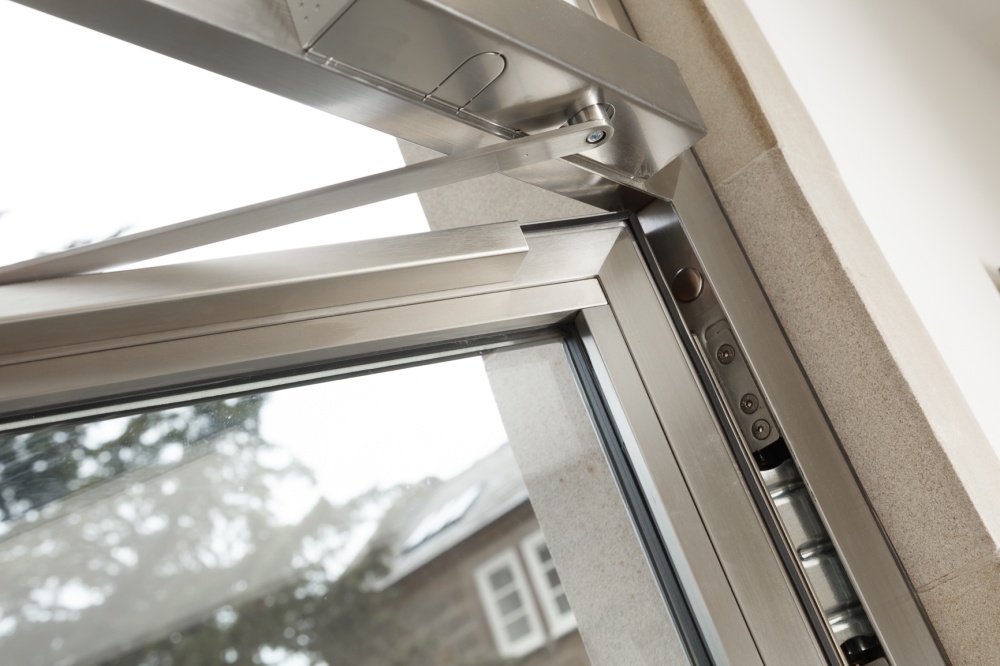 Upper corner detail with overhead closer and concealed hinge